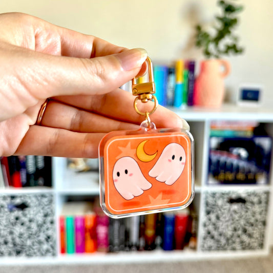 Keychain with cute ghosts and a moon on it, with a gold clasp